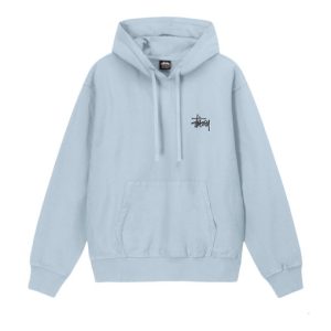 A collection of Stussy pullovers displayed on hangers, showcasing various designs and colors, embodying the brand's iconic streetwear aesthetic.